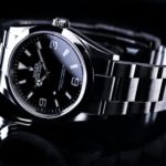 silver and black round analog watch