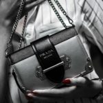 black leather handbag on white textile