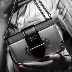 black leather handbag on white textile